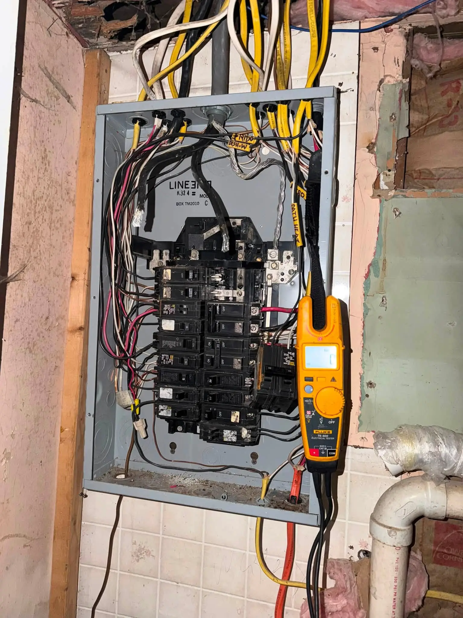 Electrical panel being tested with a digital multimeter