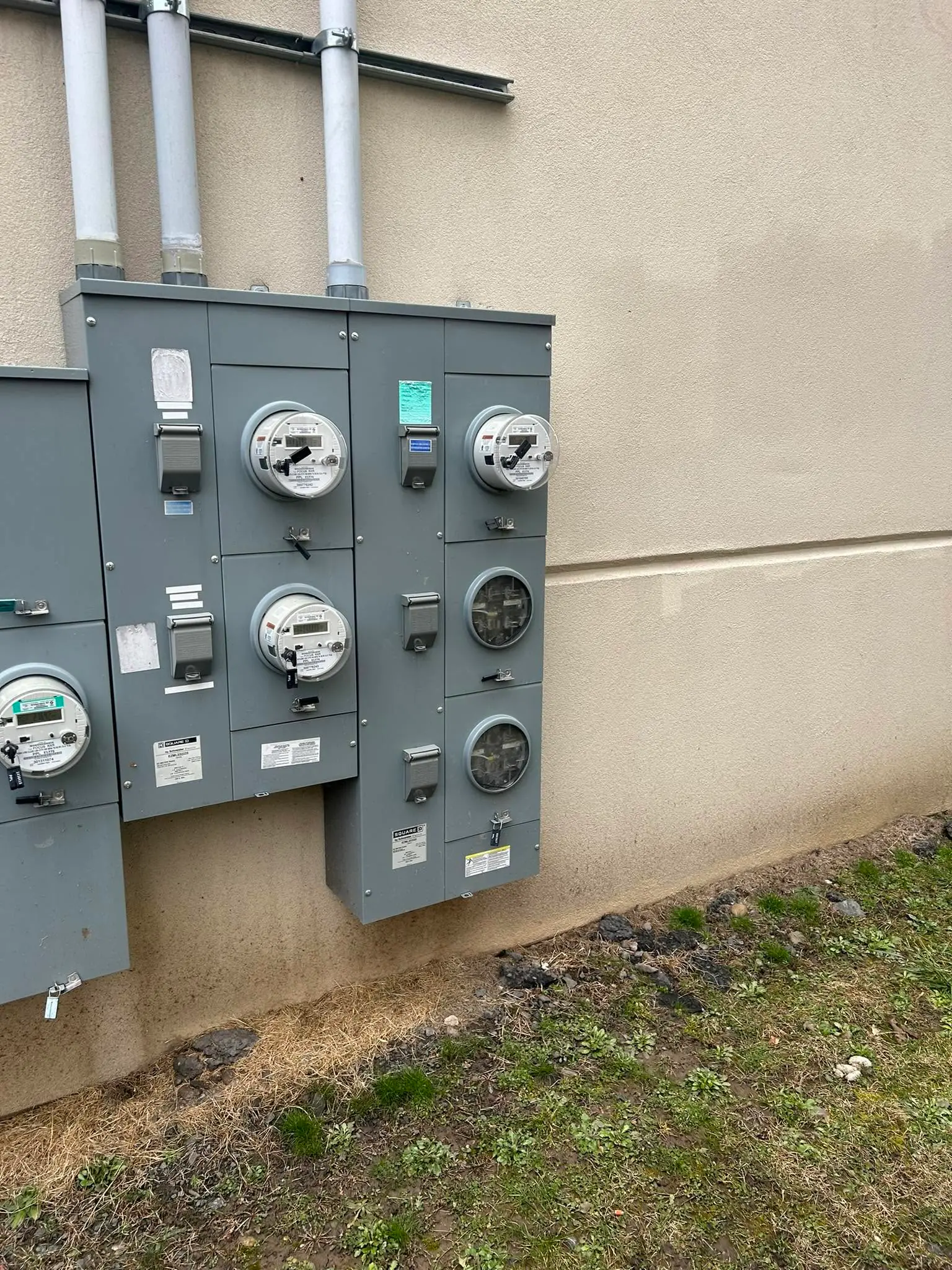 Multi-meter electrical service equipment mounted on an exterior wall